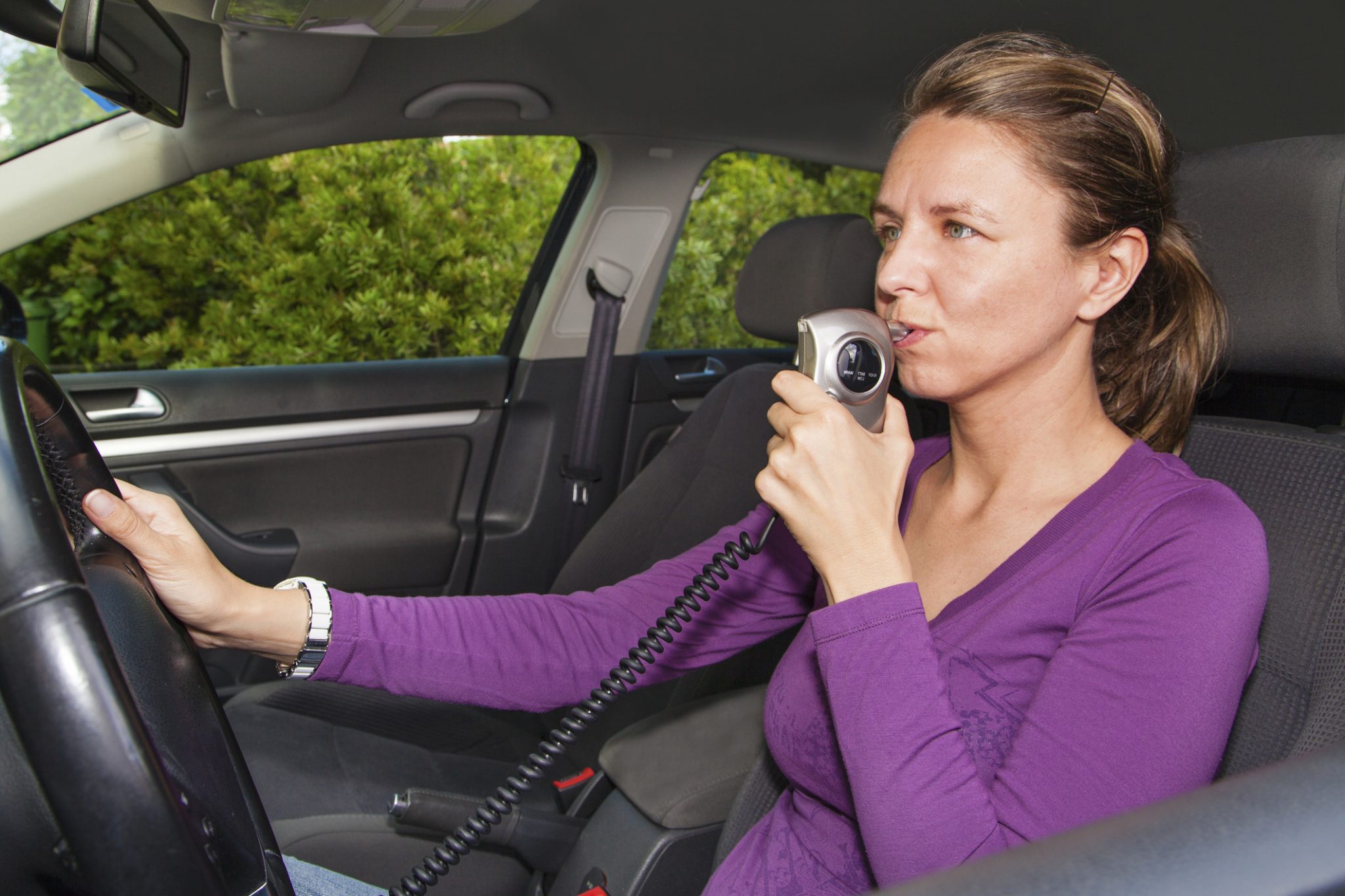 A Woman In A Car Blowing Into A Breathalyzer Steven E Kellis